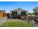 Back exterior of the house showcasing hot tub, fenced yard, and a well-maintained lawn, perfect for outdoor living at 949 Raleigh St # 2, Denver, CO 80204