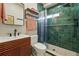 Modern bathroom with stylish wood vanity, chic mirror, and a tiled shower with a rainfall showerhead at 949 Raleigh St # 2, Denver, CO 80204