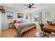 Cozy bedroom with natural light, modern decor, a ceiling fan, and hardwood floors at 949 Raleigh St # 2, Denver, CO 80204