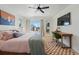 Stylish bedroom featuring a ceiling fan, hardwood floors, and an adjacent desk area at 949 Raleigh St # 2, Denver, CO 80204
