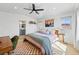 Bright bedroom boasting a ceiling fan, hardwood floors, and ensuite bathroom access at 949 Raleigh St # 2, Denver, CO 80204