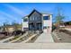 Contemporary townhouse showcasing black and white siding, with individual driveways and landscaped yards at 949 Raleigh St # 2, Denver, CO 80204