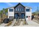 Modern farmhouse-style duplex with contrasting black and white siding and inviting curb appeal at 949 Raleigh St # 2, Denver, CO 80204