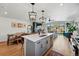 Open-concept kitchen with an island, a dining area, and a view into the living room at 949 Raleigh St # 2, Denver, CO 80204