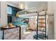 Open concept living space features a living room area, kitchen, and loft accessible by wooden ladder at 949 Raleigh St # 2, Denver, CO 80204