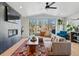 Beautiful living room with fireplace, large sectional sofa, wood floors, and access to backyard at 949 Raleigh St # 2, Denver, CO 80204