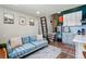 Cozy living room features a comfy blue sofa, stylish decor, and a unique ladder leading to a loft area at 949 Raleigh St # 2, Denver, CO 80204