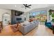 Bright living room featuring fireplace, large sectional sofa, wood floors, and sliding glass doors to the backyard at 949 Raleigh St # 2, Denver, CO 80204