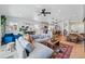 Open-concept living area with large sectional sofa, wood floors, and adjacent kitchen and dining spaces at 949 Raleigh St # 2, Denver, CO 80204
