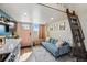 Comfortable living room with a blue sofa, light-filled window, stylish decor, and a ladder to the loft at 949 Raleigh St # 2, Denver, CO 80204