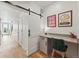 Modern office nook with desk, barn door, and stylish decor, creating a functional and appealing workspace at 949 Raleigh St # 2, Denver, CO 80204