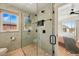 Modern shower with hexagon tile, glass door, and matte black fixtures, showcasing contemporary bathroom design at 949 Raleigh St # 2, Denver, CO 80204