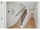 Elegant staircase with wood treads, black metal railing, and natural light, highlighting modern design at 949 Raleigh St # 2, Denver, CO 80204