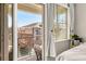 Cozy bedroom showing a balcony view and sunny window with white curtains at 8073 W 51St Pl # 303, Arvada, CO 80002