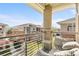 Balcony view shows the community with comfortable seating and a small table at 8073 W 51St Pl # 303, Arvada, CO 80002