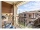Enjoy outdoor living on this balcony with views of neighboring buildings under a bright, partly cloudy sky at 8073 W 51St Pl # 303, Arvada, CO 80002