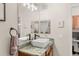 Bathroom featuring a vessel sink, granite countertop, dark faucet, and multiple mirrors at 8073 W 51St Pl # 303, Arvada, CO 80002