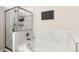 Bright bathroom featuring a soaking tub, shower with glass door, and marble-like tile at 8073 W 51St Pl # 303, Arvada, CO 80002