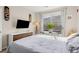 Well-lit bedroom with big window, a TV, and a lovely bedside plant at 8073 W 51St Pl # 303, Arvada, CO 80002