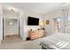Comfortable bedroom features a dresser, a mounted television, and access to a private balcony at 8073 W 51St Pl # 303, Arvada, CO 80002