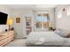 Sunlit bedroom with a large window, a gray upholstered bed, and stylish decor at 8073 W 51St Pl # 303, Arvada, CO 80002