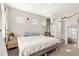 Cozy bedroom featuring neutral tones, a hanging plant, and a view into an en-suite bathroom at 8073 W 51St Pl # 303, Arvada, CO 80002