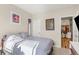 Carpeted bedroom with a white door and access to the kitchen at 8073 W 51St Pl # 303, Arvada, CO 80002