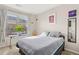 Bright bedroom with large window, minimalist decor, and carpet flooring at 8073 W 51St Pl # 303, Arvada, CO 80002