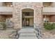 Close-up exterior view of a condo building entrance with stone accents at 8073 W 51St Pl # 303, Arvada, CO 80002