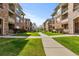 Exterior shot of a condo community with a landscaped courtyard at 8073 W 51St Pl # 303, Arvada, CO 80002