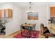 Comfortable dining area with modern table, chairs, an overhead light, and an adjacent kitchen at 8073 W 51St Pl # 303, Arvada, CO 80002