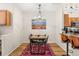 A cozy dining area with modern decor, an industrial-style table, and a view of the kitchen at 8073 W 51St Pl # 303, Arvada, CO 80002