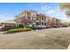 Multi-level condo building showcasing a well-maintained exterior and ample parking at 8073 W 51St Pl # 303, Arvada, CO 80002