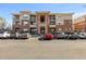 Multi-level condo building showcasing a well-maintained exterior and ample parking at 8073 W 51St Pl # 303, Arvada, CO 80002