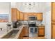 A corner view of a well equipped kitchen showing countertops and appliances at 8073 W 51St Pl # 303, Arvada, CO 80002