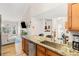 Open kitchen with granite counters, stainless steel sink, and view of living room at 8073 W 51St Pl # 303, Arvada, CO 80002