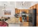 Well-lit kitchen featuring granite countertops, stainless steel appliances, and wood cabinets at 8073 W 51St Pl # 303, Arvada, CO 80002