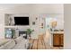 Spacious open-concept living room view featuring a fireplace, view into the kitchen and light wood flooring at 8073 W 51St Pl # 303, Arvada, CO 80002