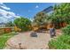 Relaxing backyard area with a stone patio, grill, and lush landscaping at 5168 Rocky Mountain Dr, Castle Rock, CO 80109
