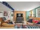 Cozy basement with sofas, TV, and sports decor perfect for entertainment and relaxation at 5168 Rocky Mountain Dr, Castle Rock, CO 80109