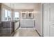 Bright bathroom featuring a double sink vanity, walk-in shower, and a soaking tub with scenic outdoor views at 5168 Rocky Mountain Dr, Castle Rock, CO 80109