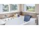 Close up on the bathtub with tile surround, decorative ledge, and large windows overlooking a scenic outdoor view at 5168 Rocky Mountain Dr, Castle Rock, CO 80109