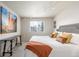 A modern bedroom with a large painting, track lighting, and view of the landscape outside at 5168 Rocky Mountain Dr, Castle Rock, CO 80109
