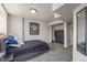 Bedroom with neutral walls, sports decor, carpeted floor, and view to entertainment area at 5168 Rocky Mountain Dr, Castle Rock, CO 80109