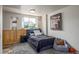 Bedroom featuring sports memorabilia, a comfortable bed, and natural light from the large window at 5168 Rocky Mountain Dr, Castle Rock, CO 80109