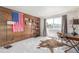 The bedroom features an American flag, unique decor, and a large window with natural light at 5168 Rocky Mountain Dr, Castle Rock, CO 80109