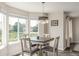 Dining area with large bright window view and modern lighting fixtures to set a lovely tone at 5168 Rocky Mountain Dr, Castle Rock, CO 80109