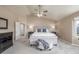 Spacious main bedroom with soft carpet, ceiling fan, and neutral walls at 5168 Rocky Mountain Dr, Castle Rock, CO 80109