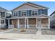 Charming two-story townhome with a stone facade and a small, well-maintained front yard at 22292 E 7Th Pl, Aurora, CO 80018