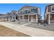Inviting two-story townhome with modern design, featuring a stone facade and cozy front porch at 22292 E 7Th Pl, Aurora, CO 80018